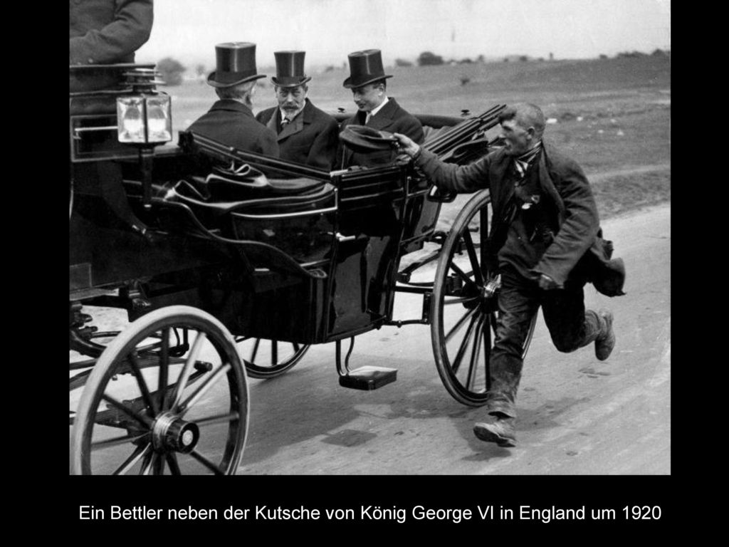 Ein Bettler neben der Kutsche von König George VI in England um 1920